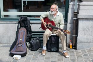 Vieil homme donnant un spectacle de rue à la guitare et au chant
